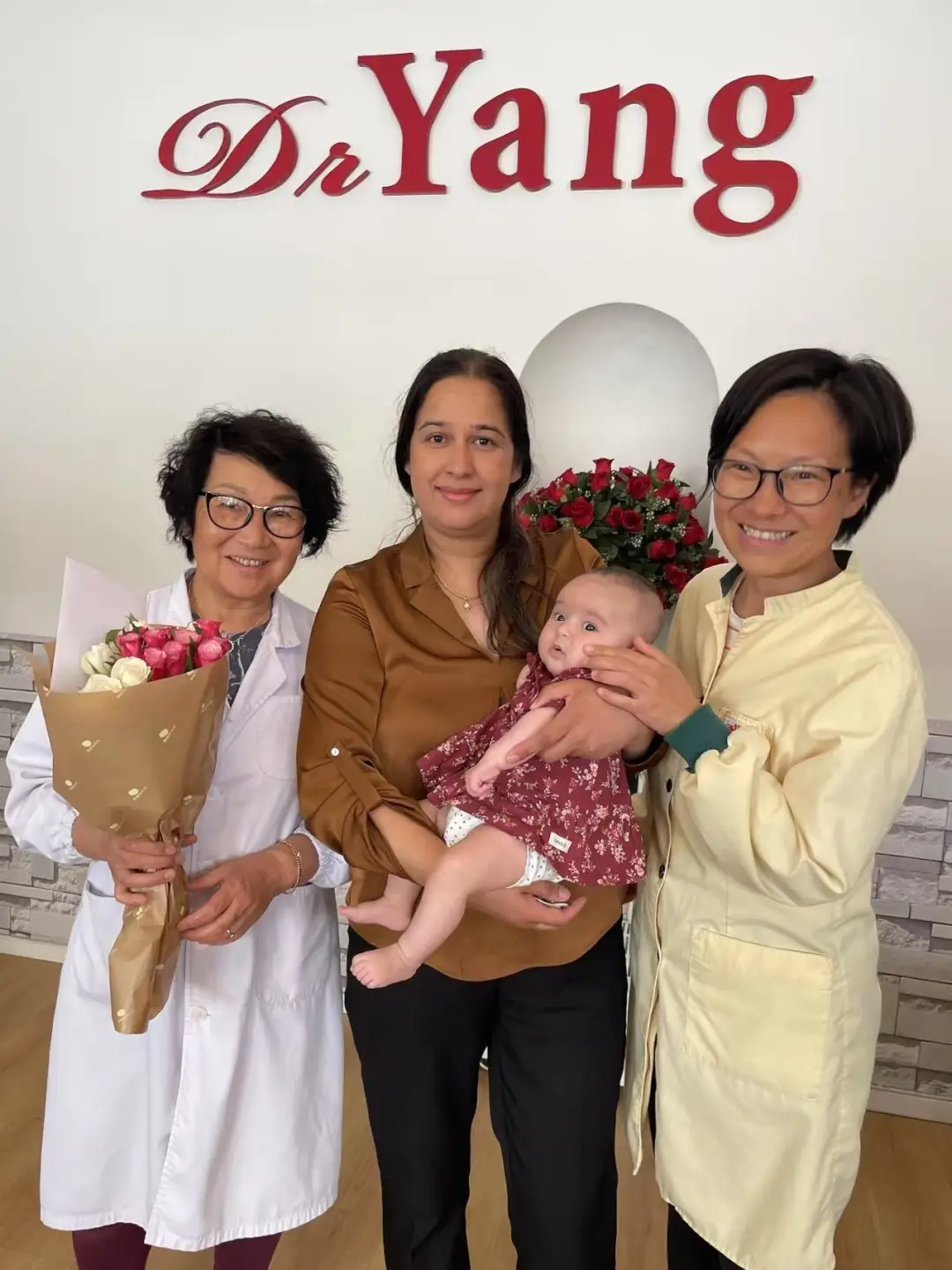 Dr Yang and Jihua with a happy patient and baby at the clinic